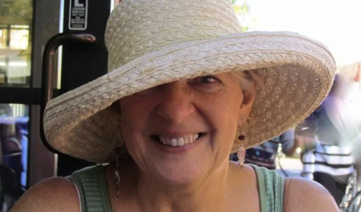 lana smiling in sun hat